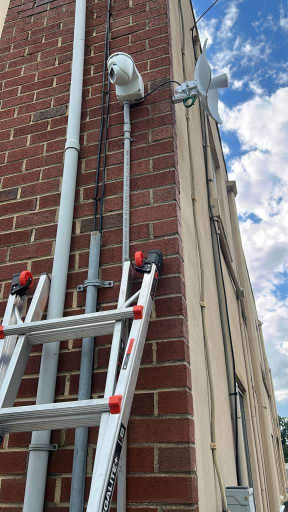 Security camera paired with a wireless bridge antenna