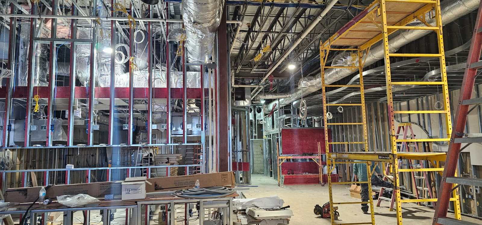Restaurant interior during construction, open steel framing and ceiling before drywall