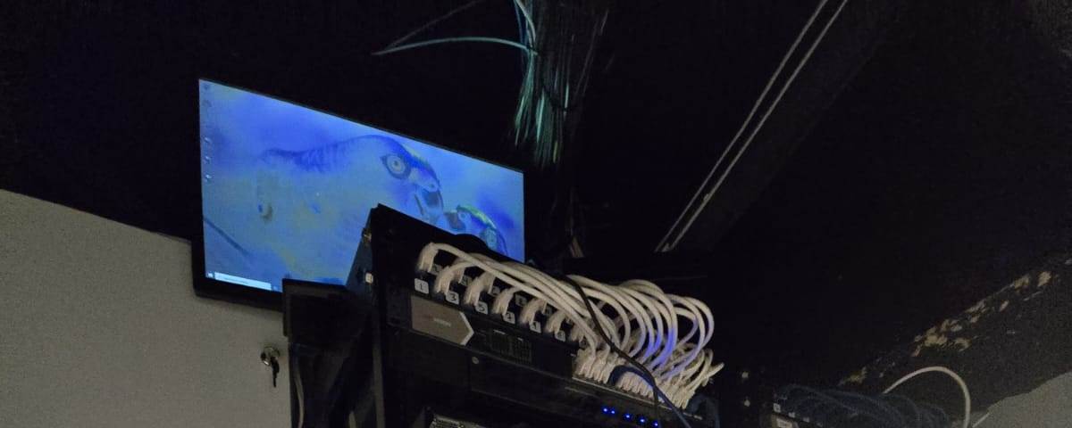 Equipment stack above a sink area before the upgrade, with unmanaged switches and tangled cabling